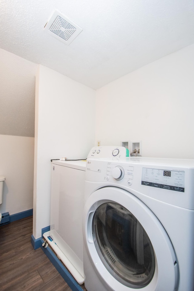 laundry room with visible vents, wood finished floors, baseboards, hookup for a washing machine, and laundry area