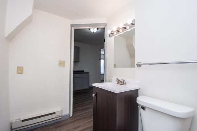 half bathroom featuring vanity, toilet, wood finished floors, and baseboard heating