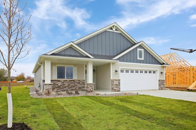 craftsman inspired home featuring board and batten siding, a front lawn, fence, stone siding, and driveway