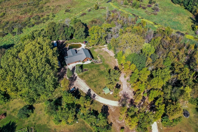 drone / aerial view featuring a wooded view