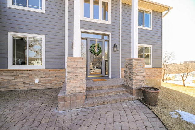 property entrance with stone siding