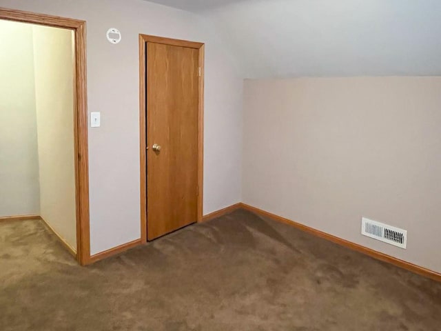 additional living space featuring lofted ceiling, carpet flooring, baseboards, and visible vents