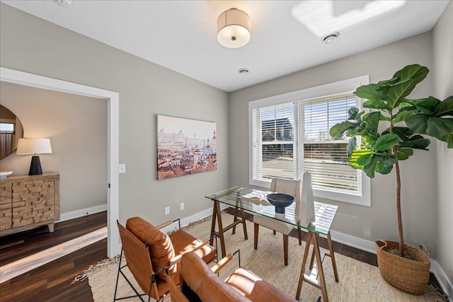 office space featuring baseboards and wood finished floors