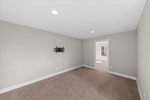 spare room featuring recessed lighting, baseboards, and carpet flooring