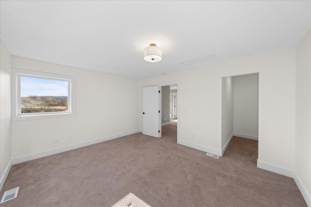 unfurnished bedroom featuring carpet flooring, baseboards, and visible vents