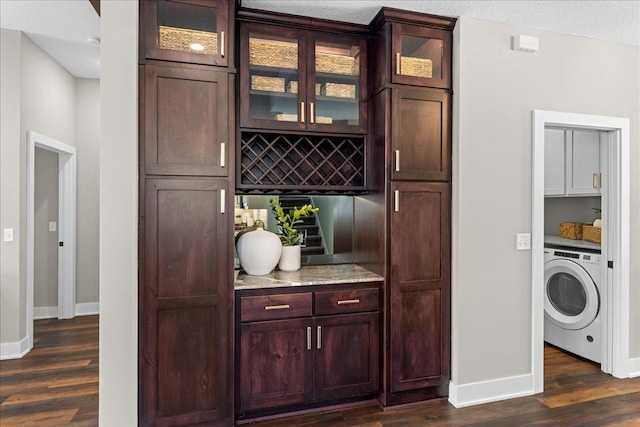 696 Inspiration Pl, Bayport, MN 55003 - bar featuring baseboards, dark wood-type flooring, and washer / dryer
