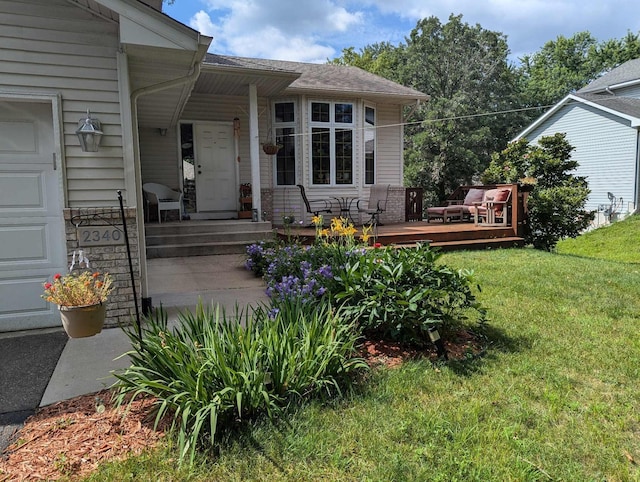 doorway to property with a lawn and an attached garage