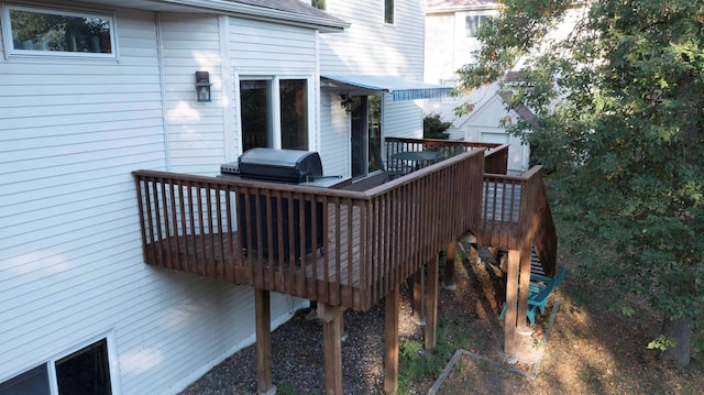 wooden deck featuring stairway and area for grilling