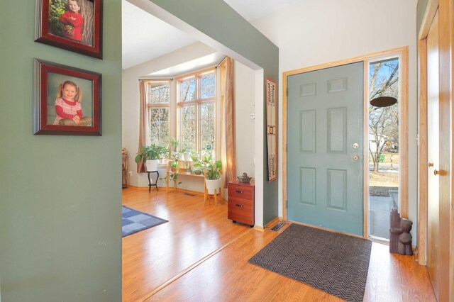 entryway with wood finished floors and visible vents