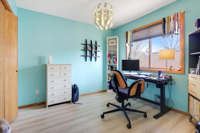 office space featuring baseboards, an inviting chandelier, and wood finished floors