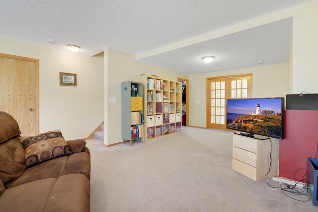 living room with stairway, a textured ceiling, baseboards, and carpet floors