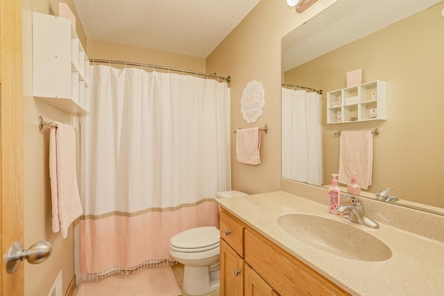 bathroom featuring curtained shower, toilet, vanity, and a textured ceiling