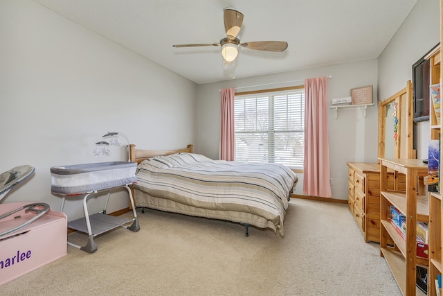 carpeted bedroom with baseboards and ceiling fan