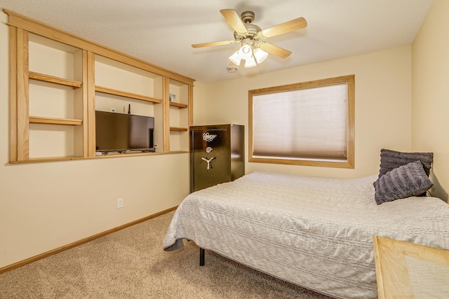 carpeted bedroom featuring a ceiling fan and baseboards