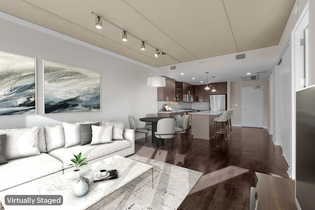 living room featuring visible vents and dark wood-style flooring