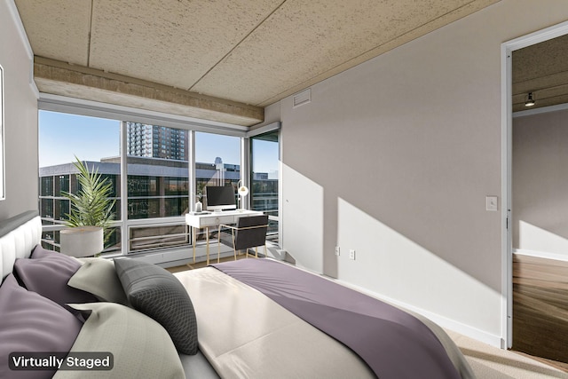 bedroom with baseboards and visible vents