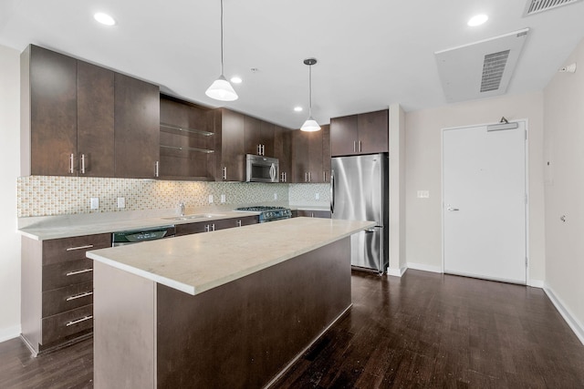 kitchen featuring dark wood-type flooring, dark brown cabinetry, light countertops, stainless steel appliances, and a sink