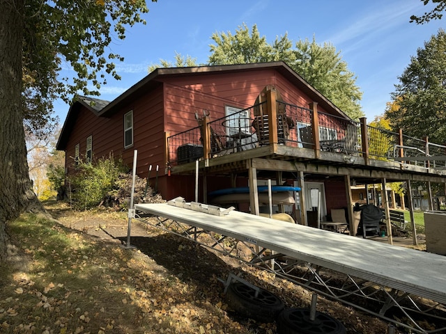 rear view of property featuring a deck