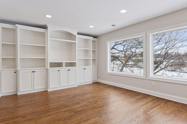 interior space with recessed lighting, wood finished floors, and baseboards