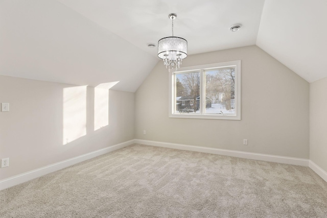 bonus room with visible vents, lofted ceiling, an inviting chandelier, carpet flooring, and baseboards