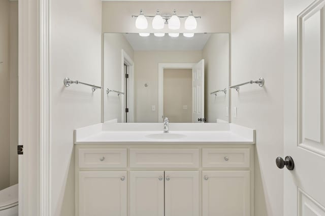 bathroom with toilet and vanity