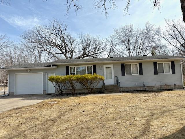 ranch-style home featuring entry steps, concrete driveway, and an attached garage