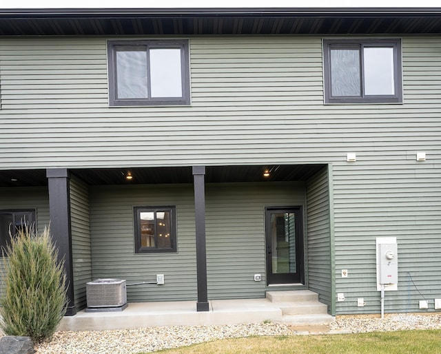 back of property featuring central AC unit