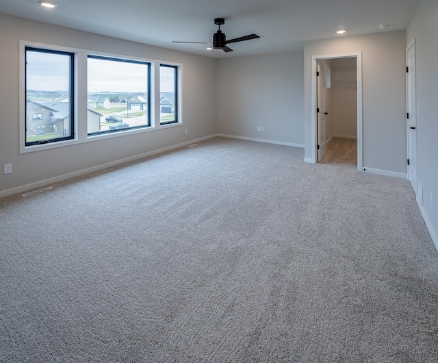 spare room with a ceiling fan, carpet flooring, recessed lighting, and baseboards