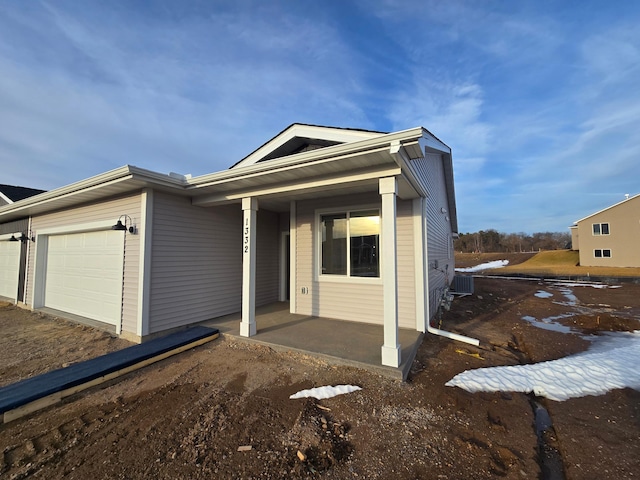 view of front of house with central AC and a garage