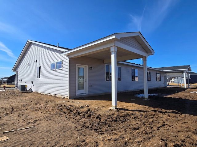 rear view of house featuring central AC unit