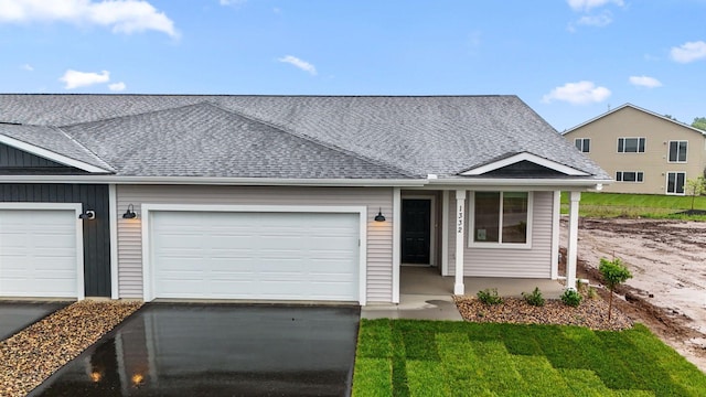 1332 Rose St, New Richmond, WI 54017 - view of front of property featuring a shingled roof, driveway, an attached garage, and a porch