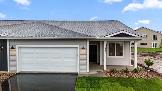1332 Rose St, New Richmond, WI 54017 - ranch-style house with roof with shingles, asphalt driveway, and a garage