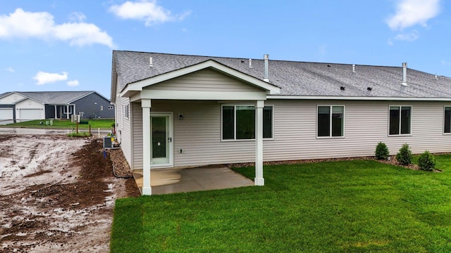 1332 Rose St, New Richmond, WI 54017 - back of house featuring a patio, a yard, central AC, and roof with shingles