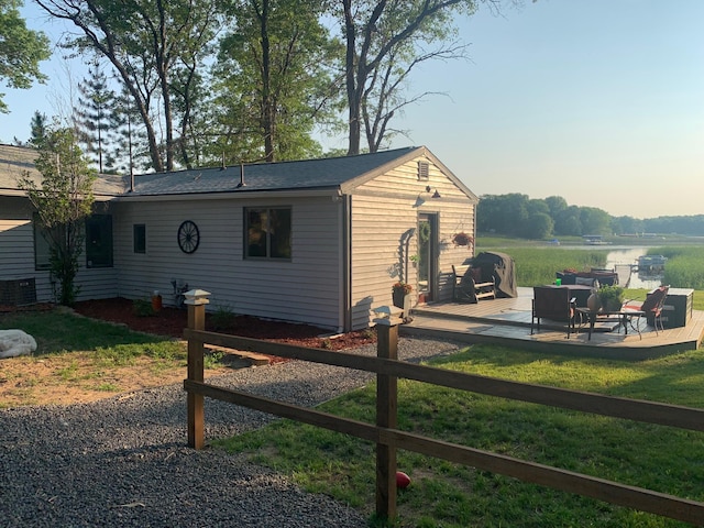 view of side of property with cooling unit, a patio area, and a yard