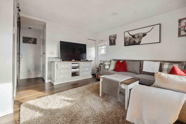 living area featuring baseboards and dark wood-style flooring