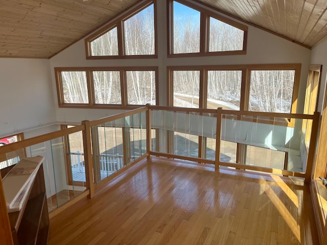 interior space featuring a healthy amount of sunlight, wooden ceiling, and vaulted ceiling