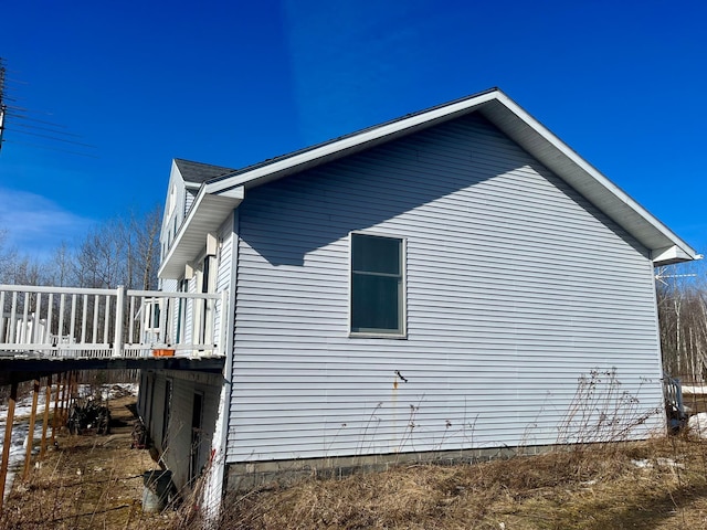 view of home's exterior featuring a wooden deck