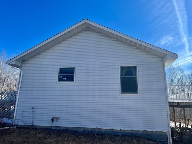 view of side of home with a wooden deck