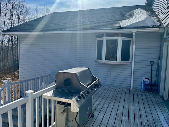 wooden terrace featuring a grill