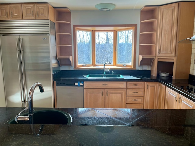 kitchen with a sink, appliances with stainless steel finishes, and open shelves