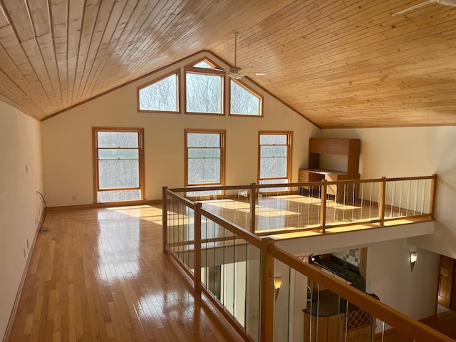 additional living space featuring high vaulted ceiling, hardwood / wood-style floors, baseboards, wood ceiling, and ceiling fan