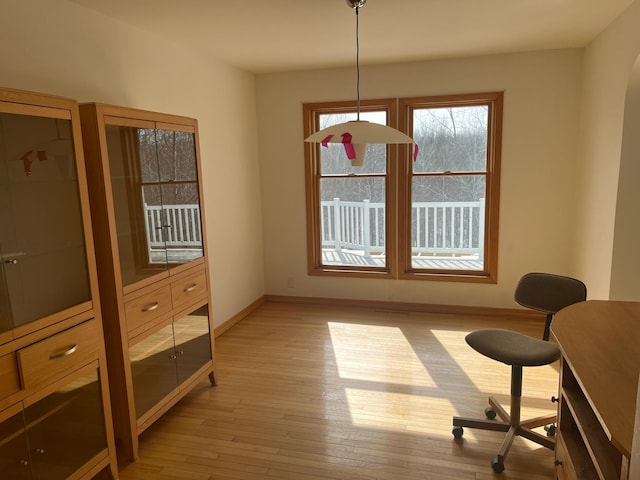 dining room with light wood-type flooring and baseboards