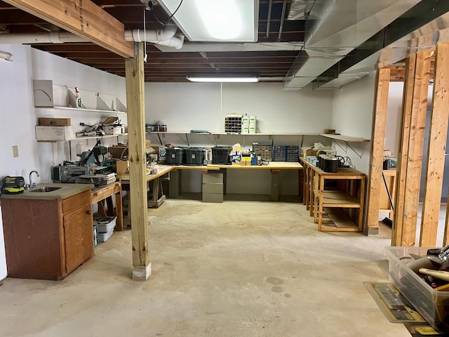 unfinished basement with a sink and a workshop area