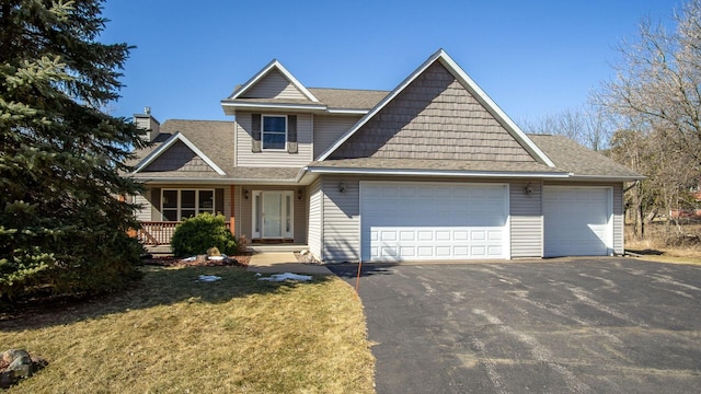 view of front of property featuring a garage, roof with shingles, a porch, and driveway