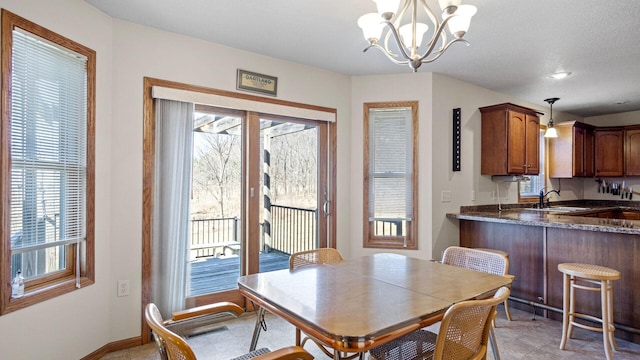 dining area with a notable chandelier and baseboards