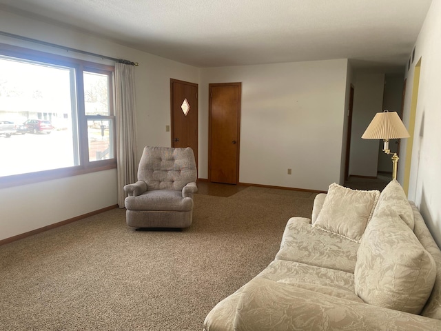 carpeted living area with baseboards