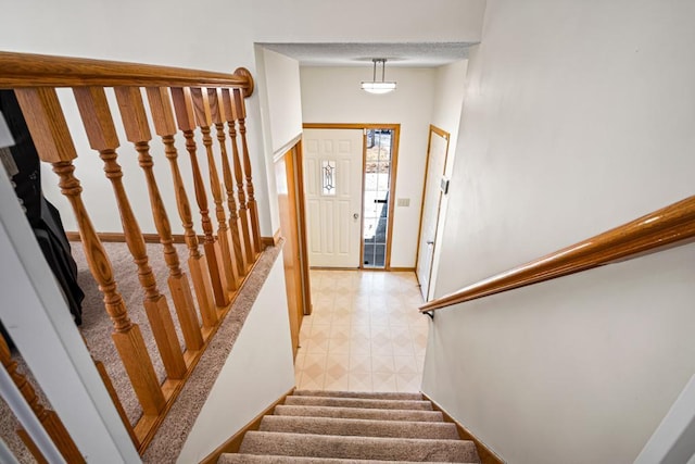 stairway featuring baseboards