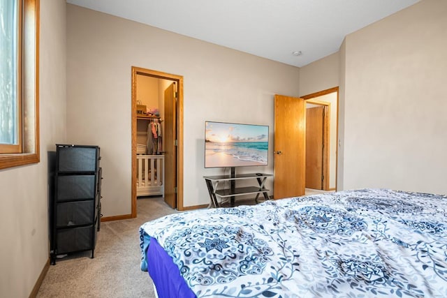 bedroom featuring light colored carpet and baseboards