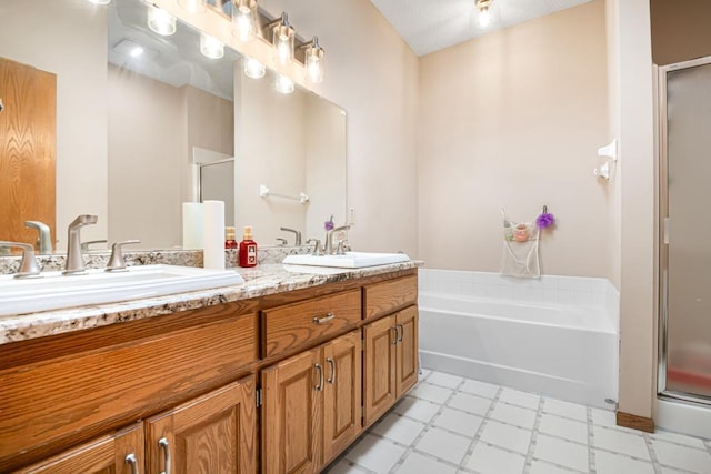 bathroom featuring tile patterned floors, double vanity, a shower stall, and a sink