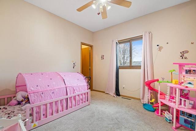 carpeted bedroom with visible vents, ceiling fan, and baseboards